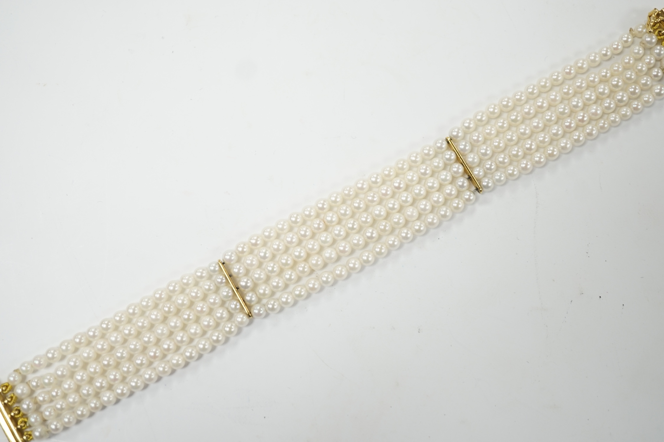 A modern multi-strand cultured pearl bracelet, with 18ct gold clasp, 17cm, gross weight 16.3 grams. Good condition.